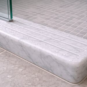 Shower curb marble threshold separating wet area from bathroom floor