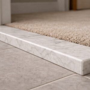 Tile-to-carpet marble threshold bridging flooring edges at doorway